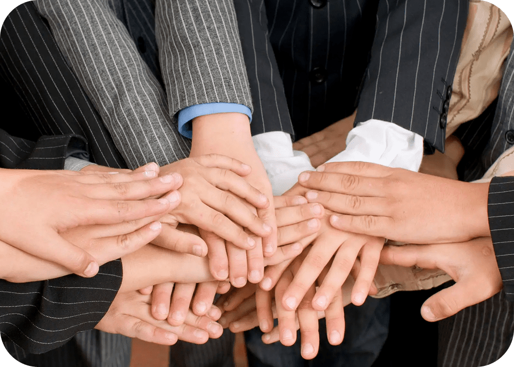Team members joining hands together